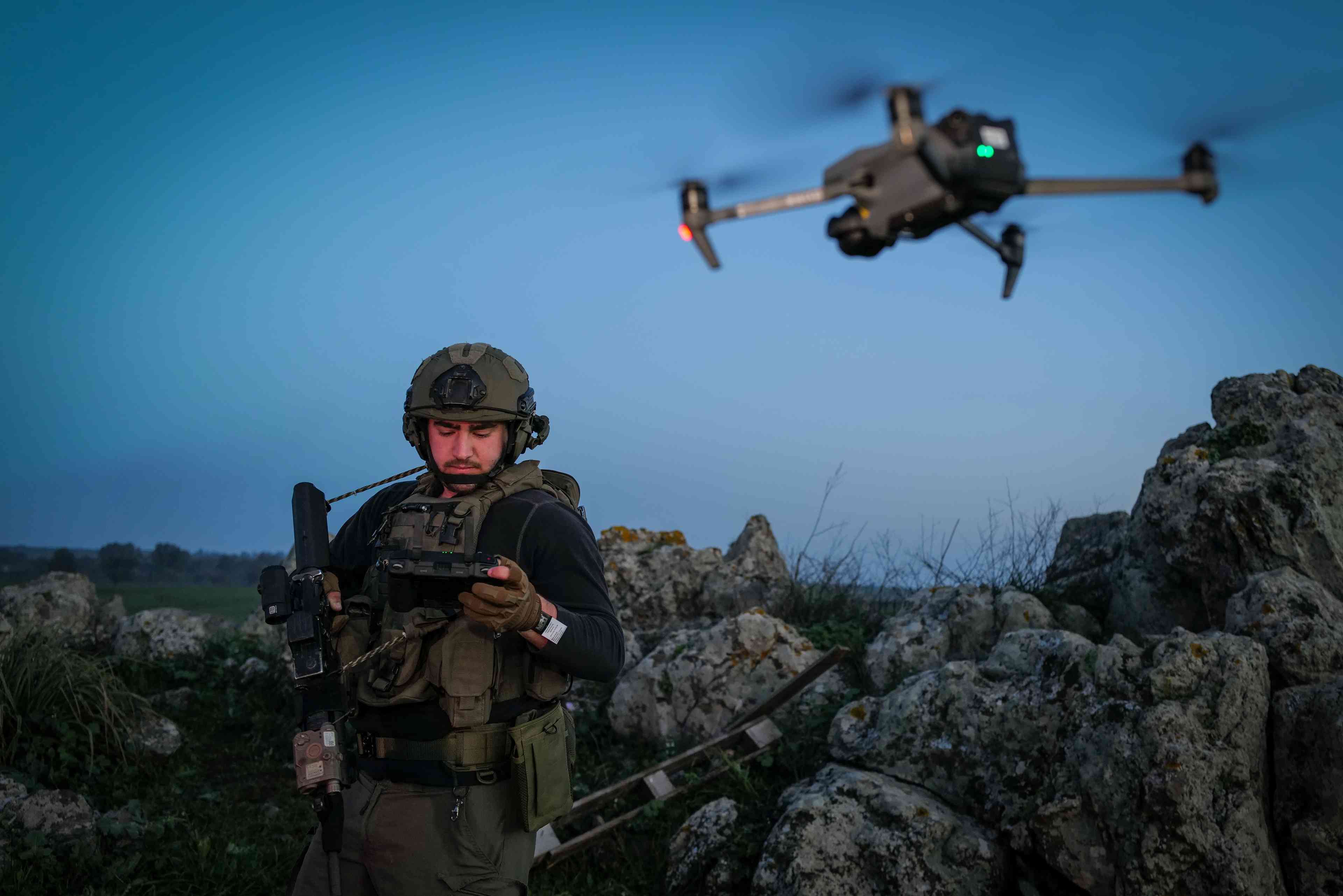 An Israeli soldier operates a drone in the Golan Heights on February 11, 2024.  background