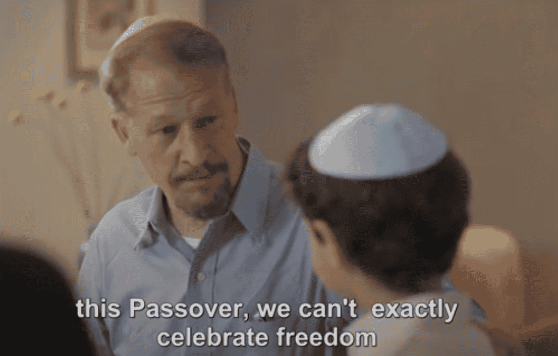 Father explaining to son how this Passover is different in Hostages Families Forum ad. background
