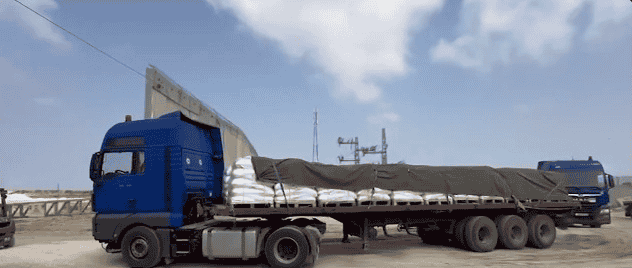 Trucks bringing in aid via Erez crossing. background