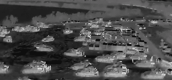 Tanks, AFVs, and bulldozers assembled to enter Rafah. background