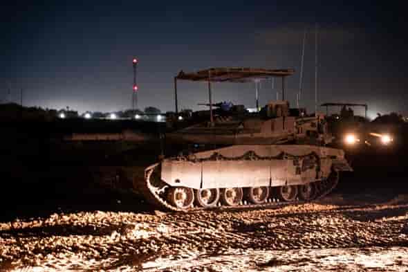 Armored vehicle operating at night in Rafah area. background