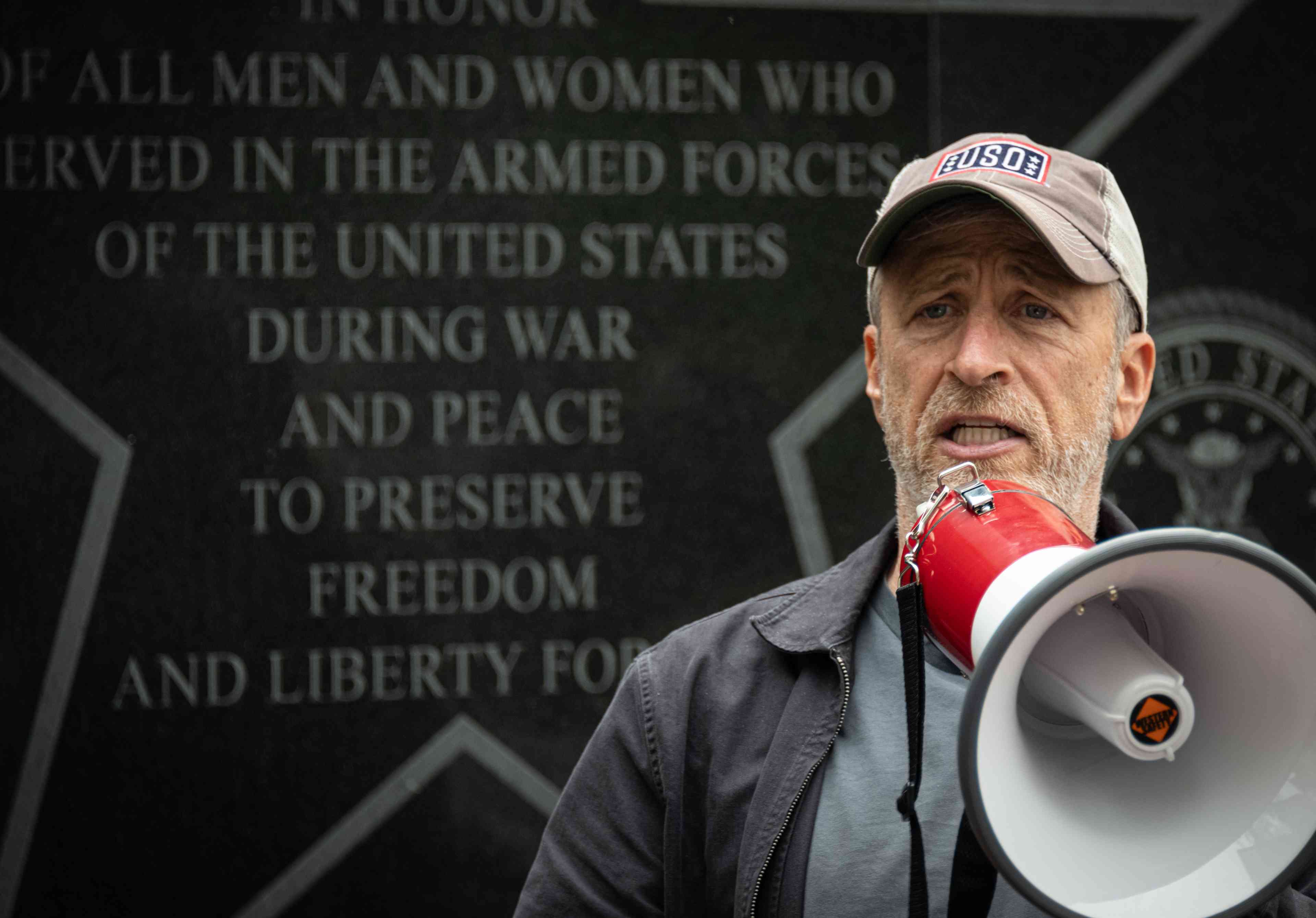 Actor turned Activist Jon Stewart gives remarks at a PACT Act rally to support funding veterans who are victims of burn pit related illnesses. background
