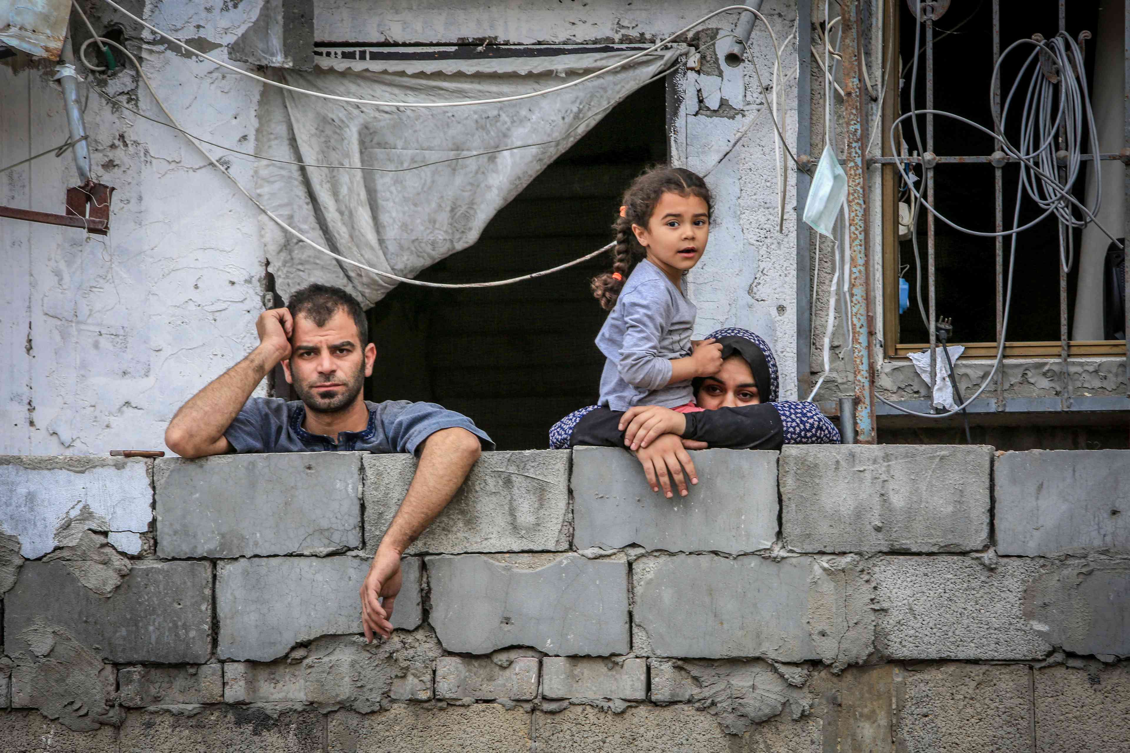 Palestinians inspect the massive destruction of the house belonging to the Al-Khatib family after it was destroyed in an Israeli air strike, in the city of Rafah, southern Gaza Strip, on April 29, 2024. background