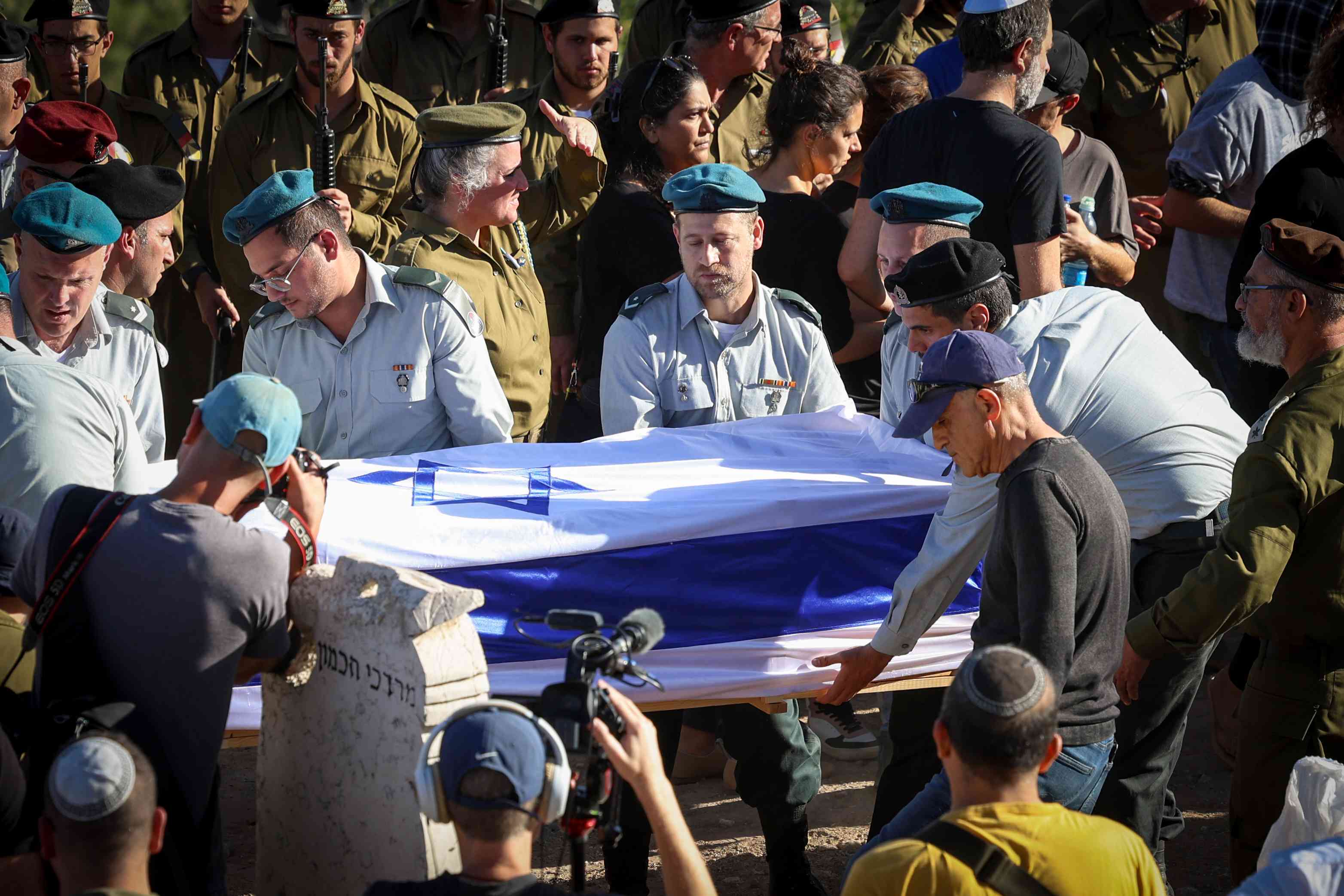 Funeral for soldier fallen in Swords of Iron War. background