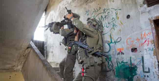 IDF soldiers in Gaza background