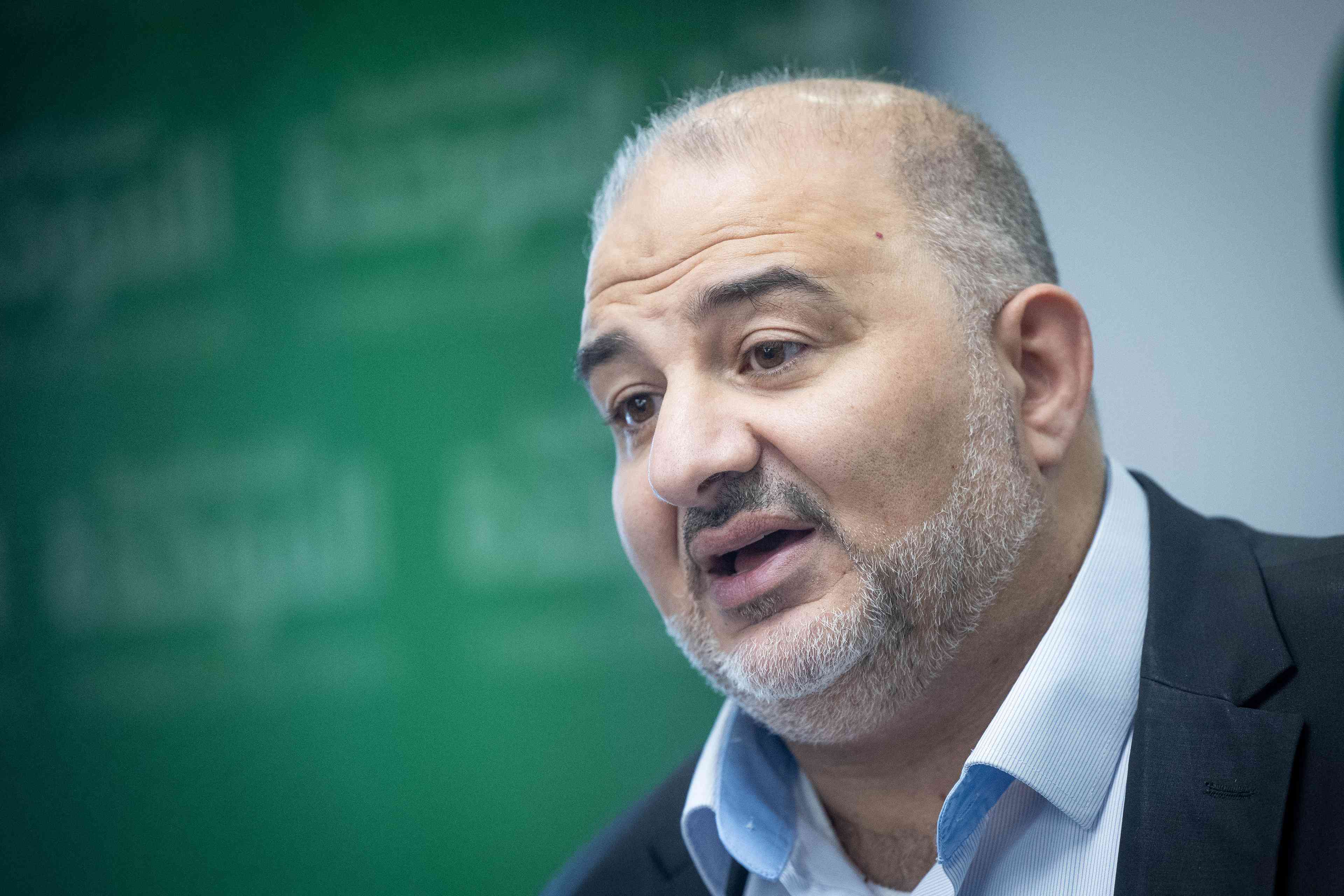 Ra'am Party Chairman Mansour Abbas. background