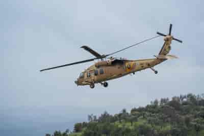 A Military helicopter evacuates injured people from the Ziv Medical Center in Tzfat, after being injured, February 14, 2024. background