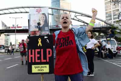 Demonstrators call for the release of Israeli hostages held in the Gaza Strip outside Hakirya Base in Tel Aviv, May 8, 2024. background