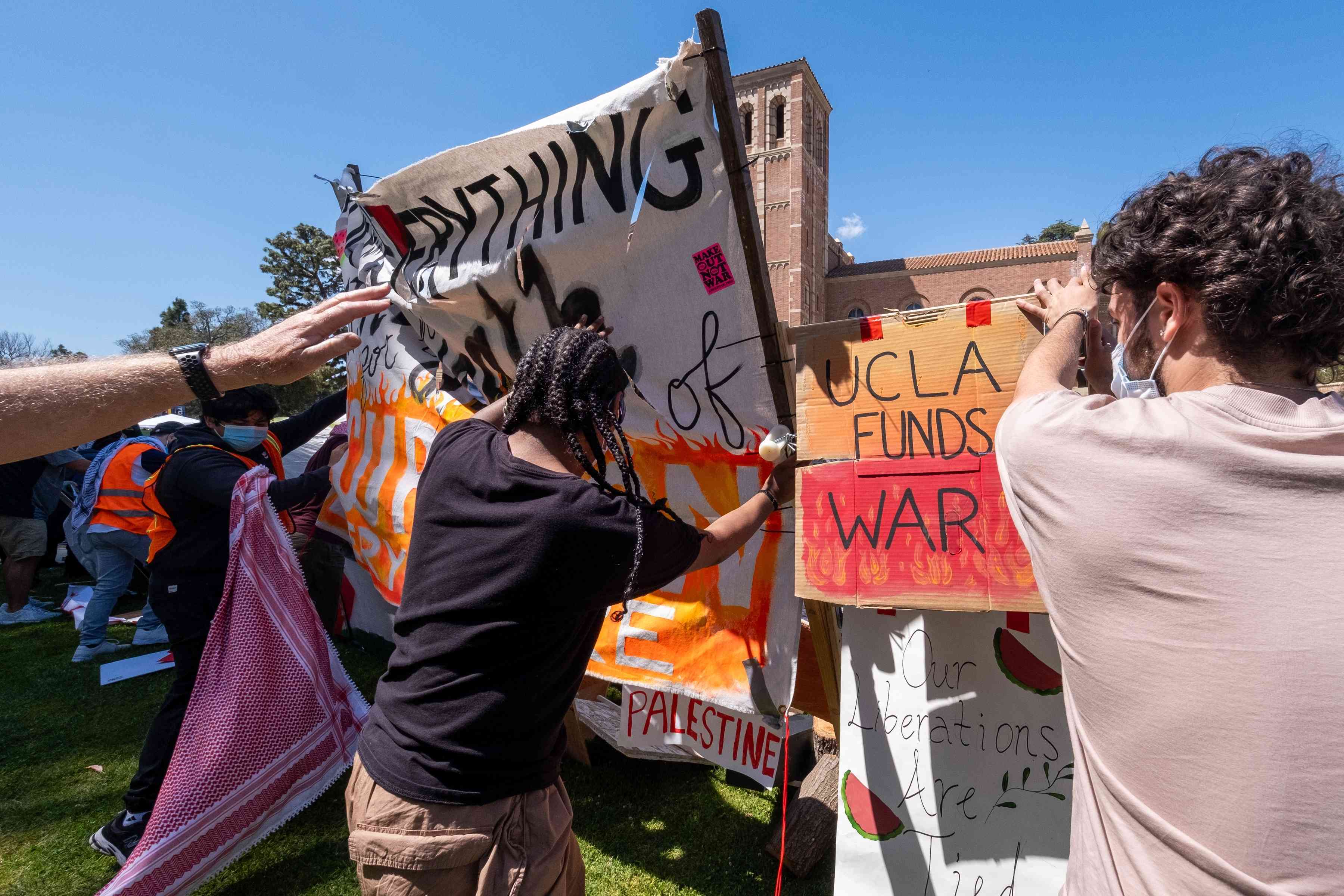 Pro-Palestinian protesters at an encampment at UCLA. Friday, April 26, 2024, background