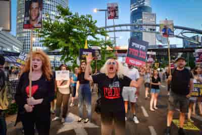Demonstrators call for the release of Israeli hostages held in the Gaza Strip outside Hakirya Base in Tel Aviv, June 17, 2024. background
