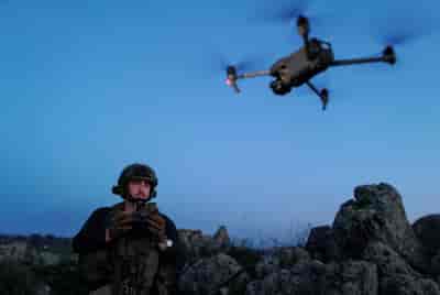 An Israeli soldier operates a drone in the Golan Heights on February 11, 2024.  background