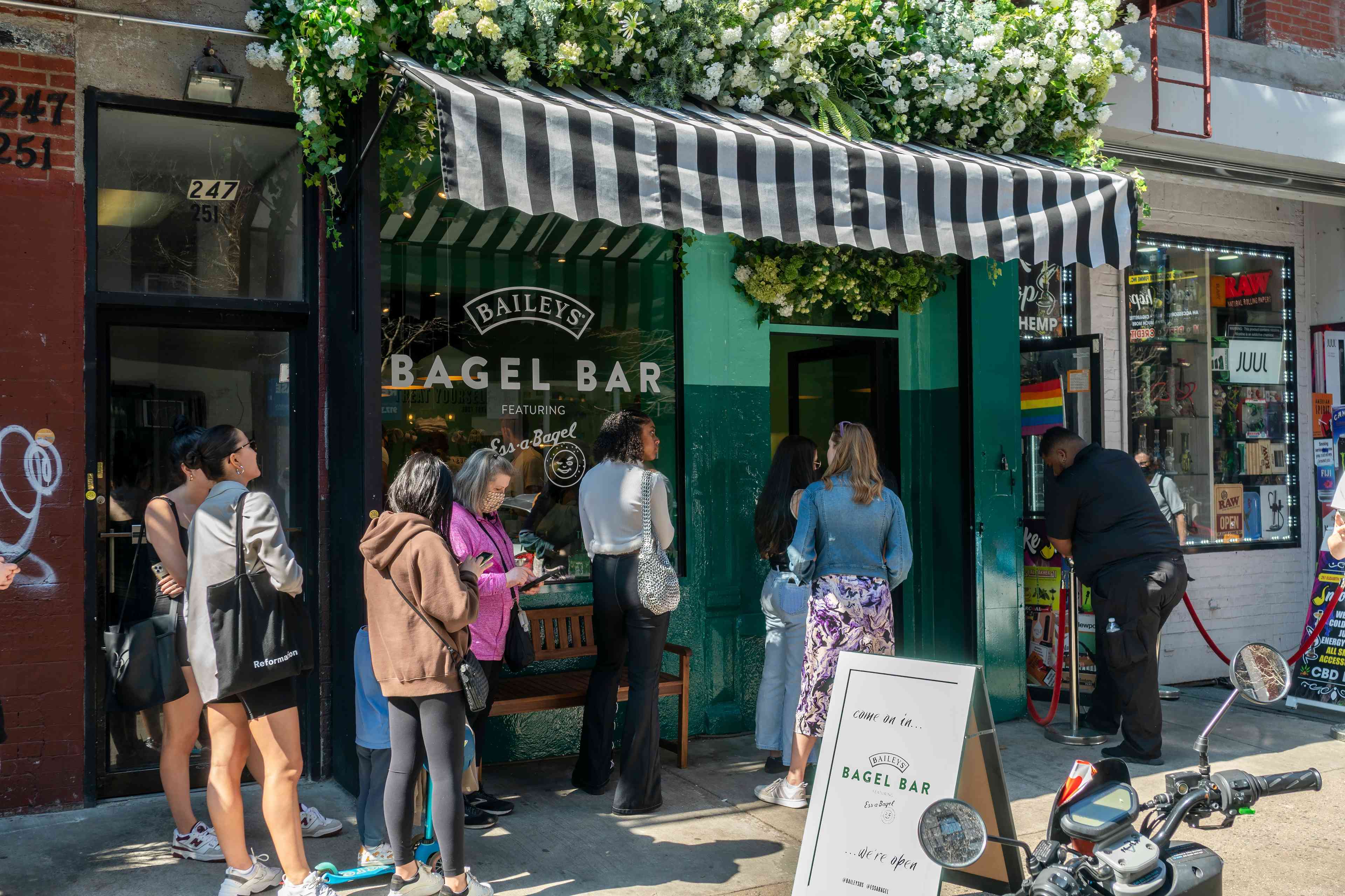 Participants wait in line outside Bagel store in New York. background