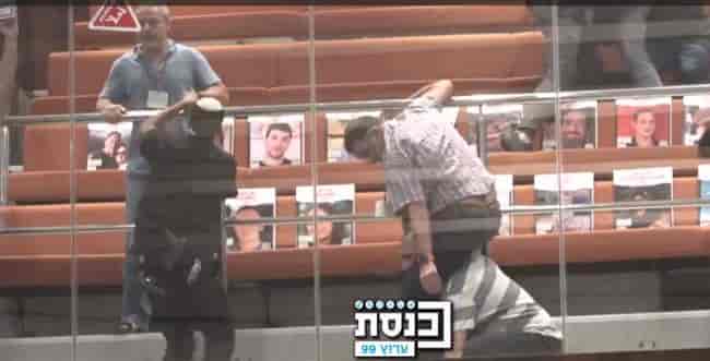 Protestors clashing in the Knesset with ushers. background