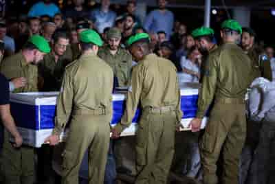Friends and family attend the funeral of Israeli soldier Staff sergeant Tzur Avraham at the military cemetery in Modi'in June 16, 2024. background