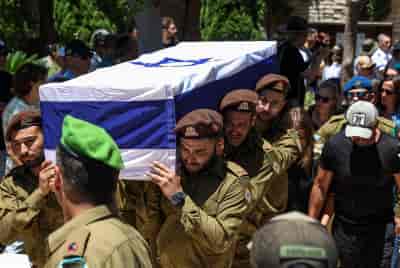 Family and friends of Israeli soldier Sergeant first class (res.) Omer Smadga attend his funeral at the military cemetery in Netanya on June 21, 2024. He was killed in combat in the Gaza Strip. background