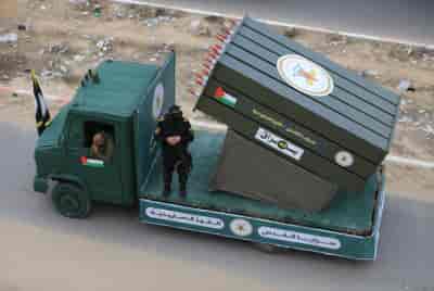 Members of the Al-Quds Brigades, the military wing of the Islamic Jihad movement in Palestine, display new missiles, October 4, 2023. background