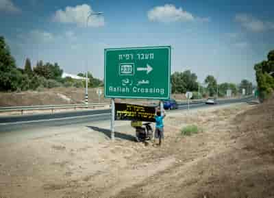 Sign pointing to Rafah Crossing near the border with Gaza in Southern Israel during Israel's Operation Protective Edge. background