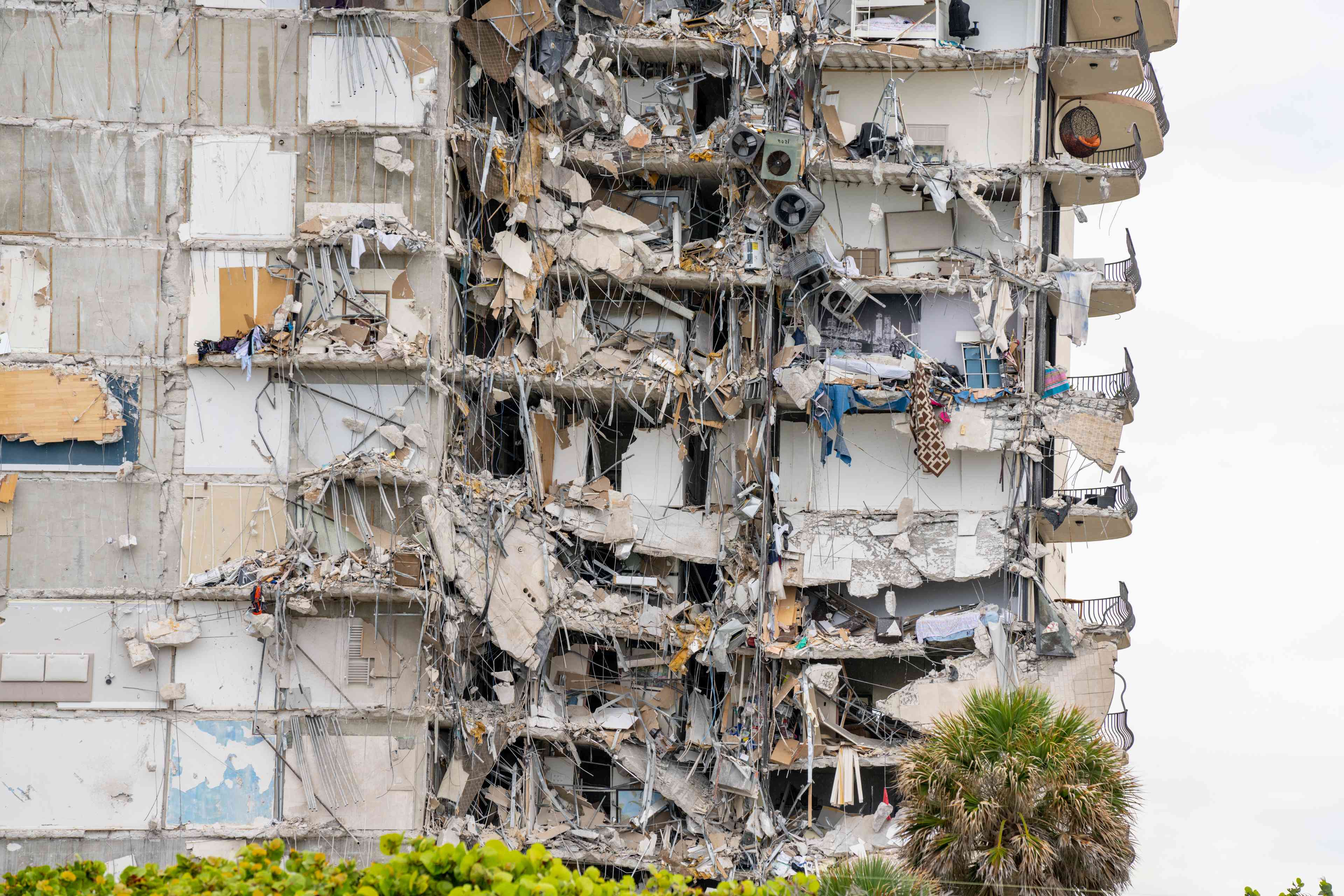Aftermath of the Champlain Towers collapse showing building rubble background