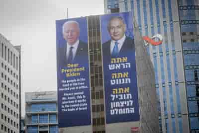Large billboards of Israeli PM Benjamin Netanyhau and US President Joe Biden , in Ramat Gan, March 4, 2024.  background