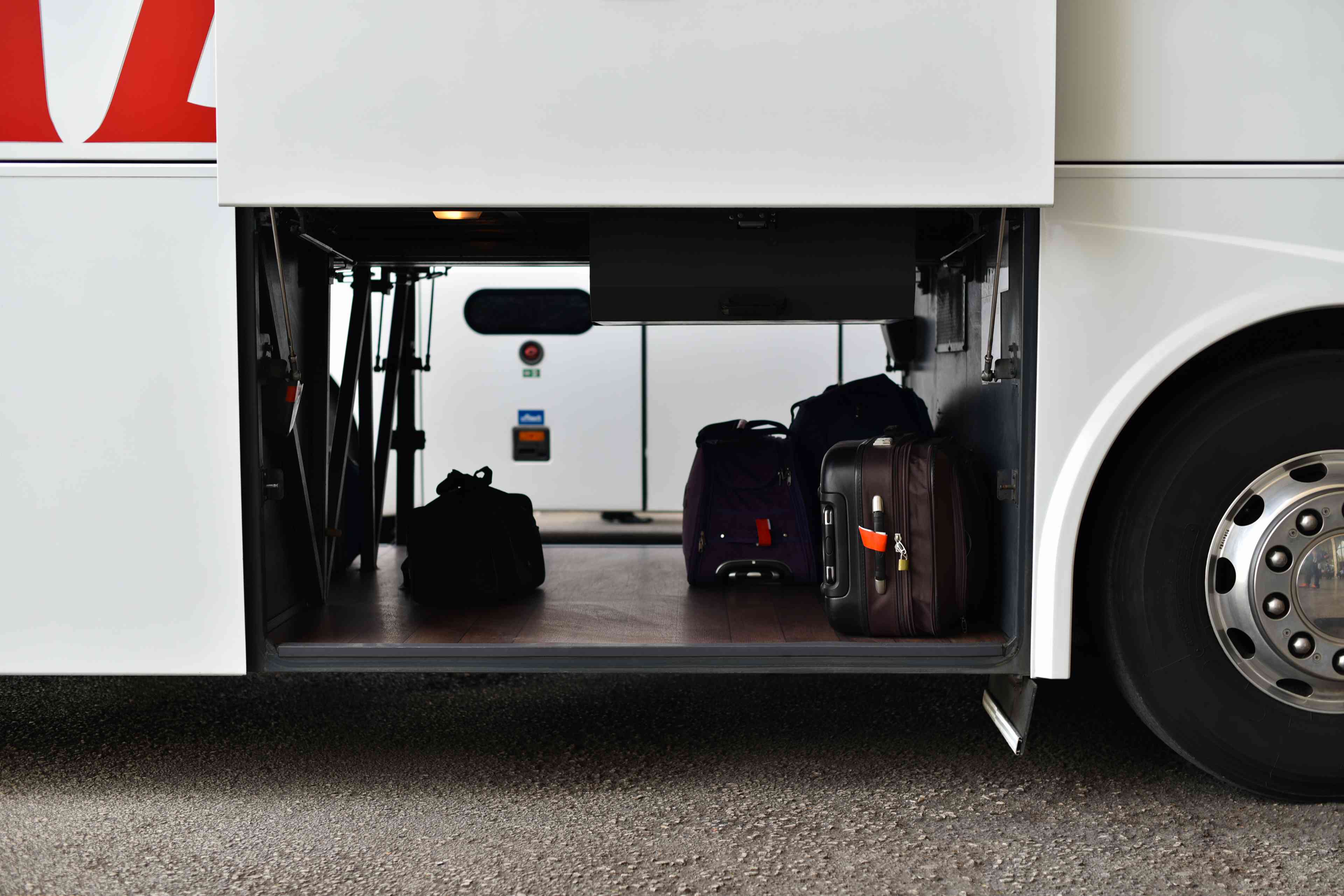 Illustrative: Bus trunk with luggage background