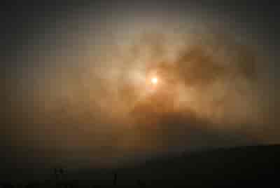 Israeli firefighters try to extinguish a fire after missiles launched from Lebanon hit open areas in the Golan Heights, Northern Israel, on July 3, 2024. background