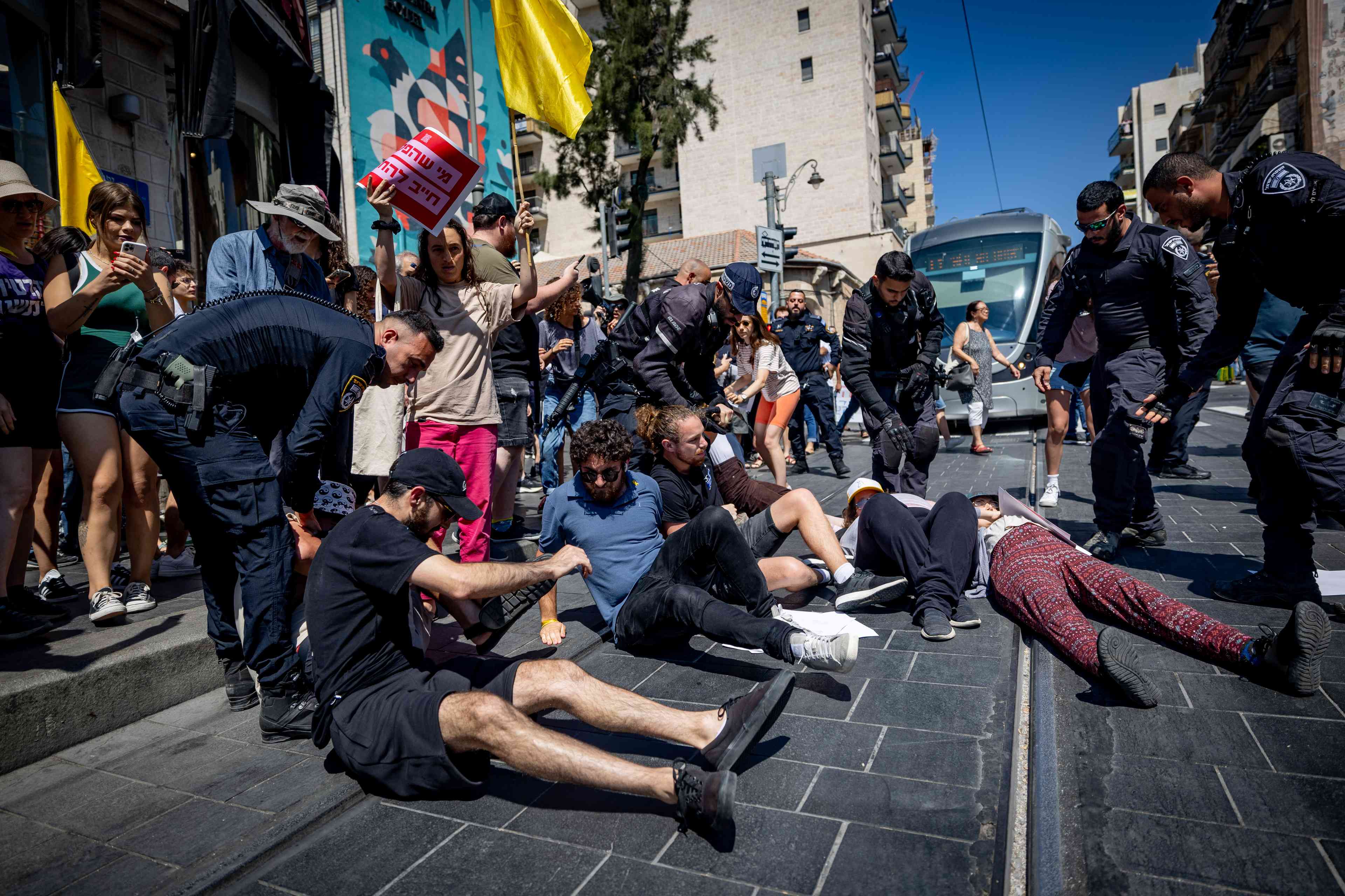 Protestors blocking tram line in Jerusalem background