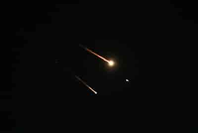 Anti-missile system fires interception missiles as drones and missiles fired from Iran. background