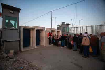 Israeli security forces guard the Qalandia checkpoint near the West Bank city of Ramallah  background