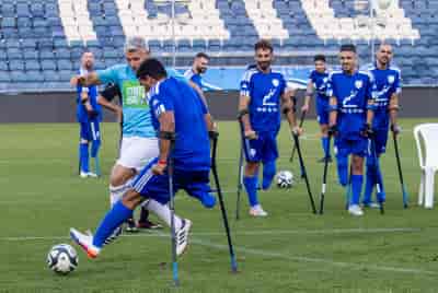 Israel's national amputee soccer team, some injured in the recent war playing during a friendly match, Teddy Stadium, Jerusalem, May 29, 2024. background