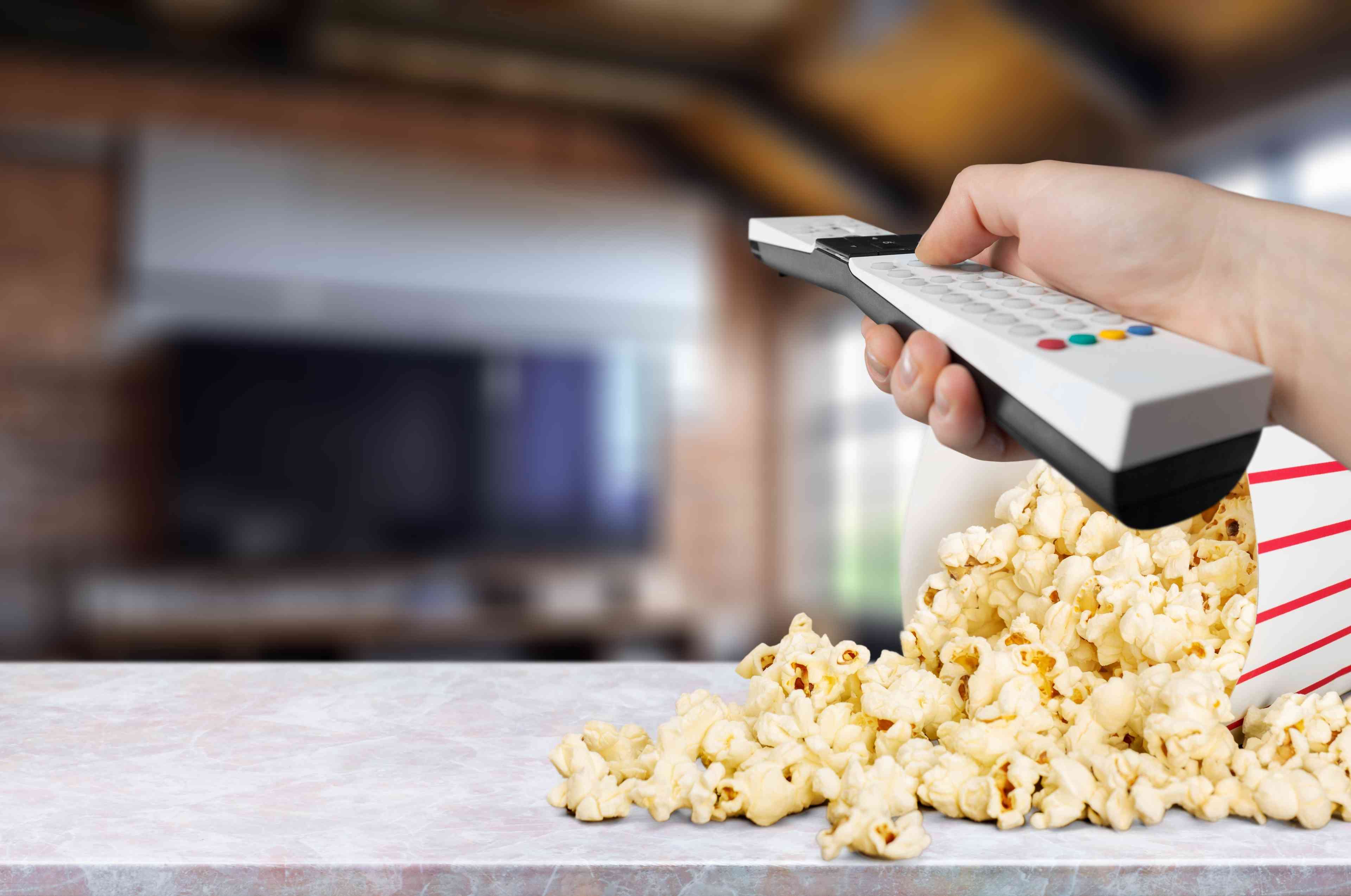 Popcorn and TV remote control  background