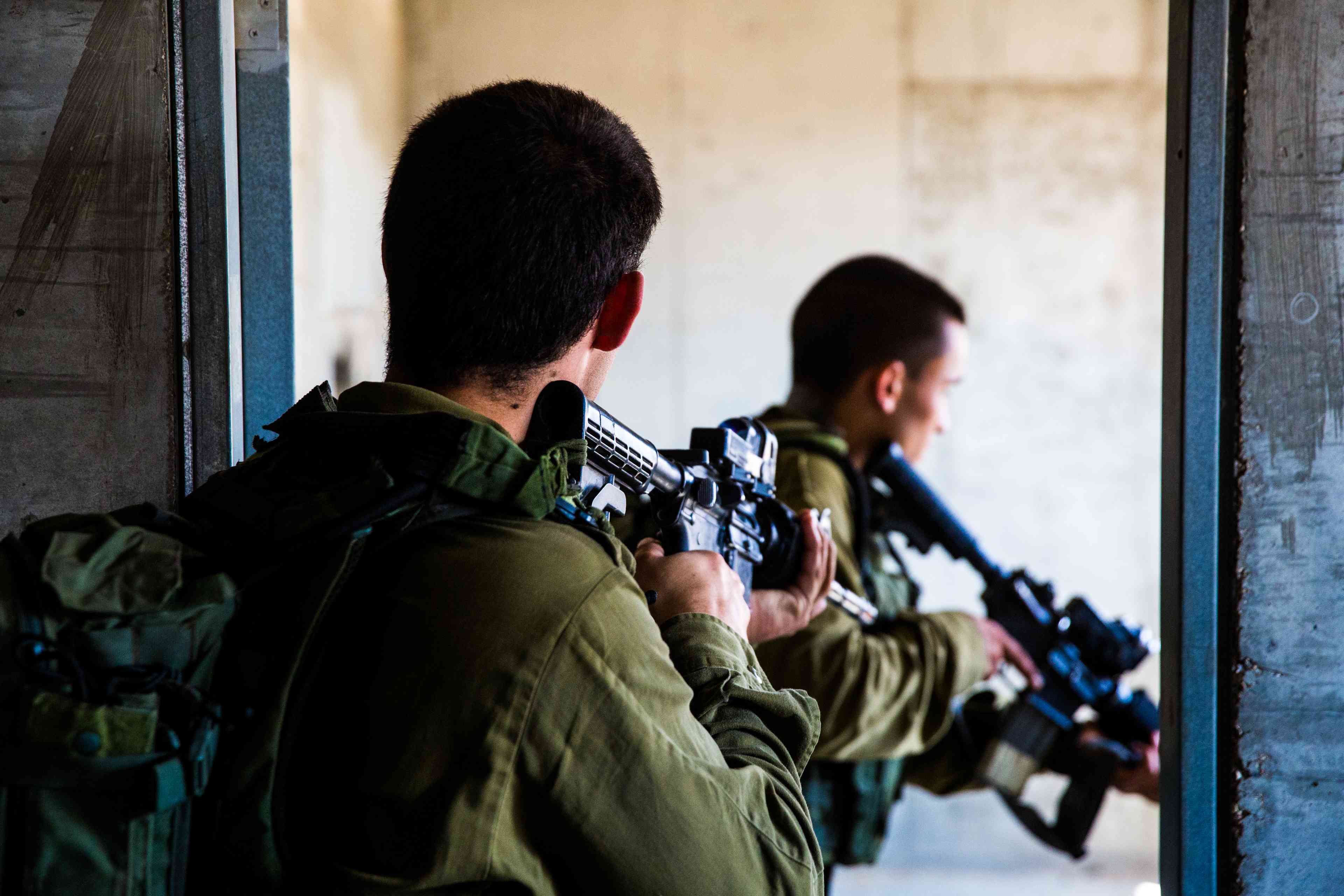 Israeli soldiers training in combat in an urban area background