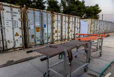 The forensic center in the Shura military base, where hundreds of dead bodies arrived since the start of the war with Gaza background