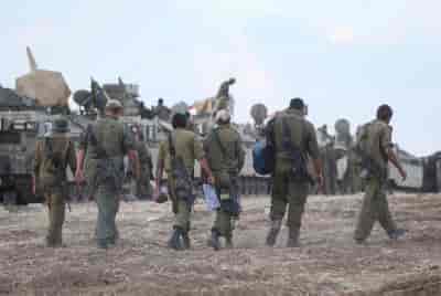 IDF reservist soldiers near the border with Gaza, in Southern Israel background