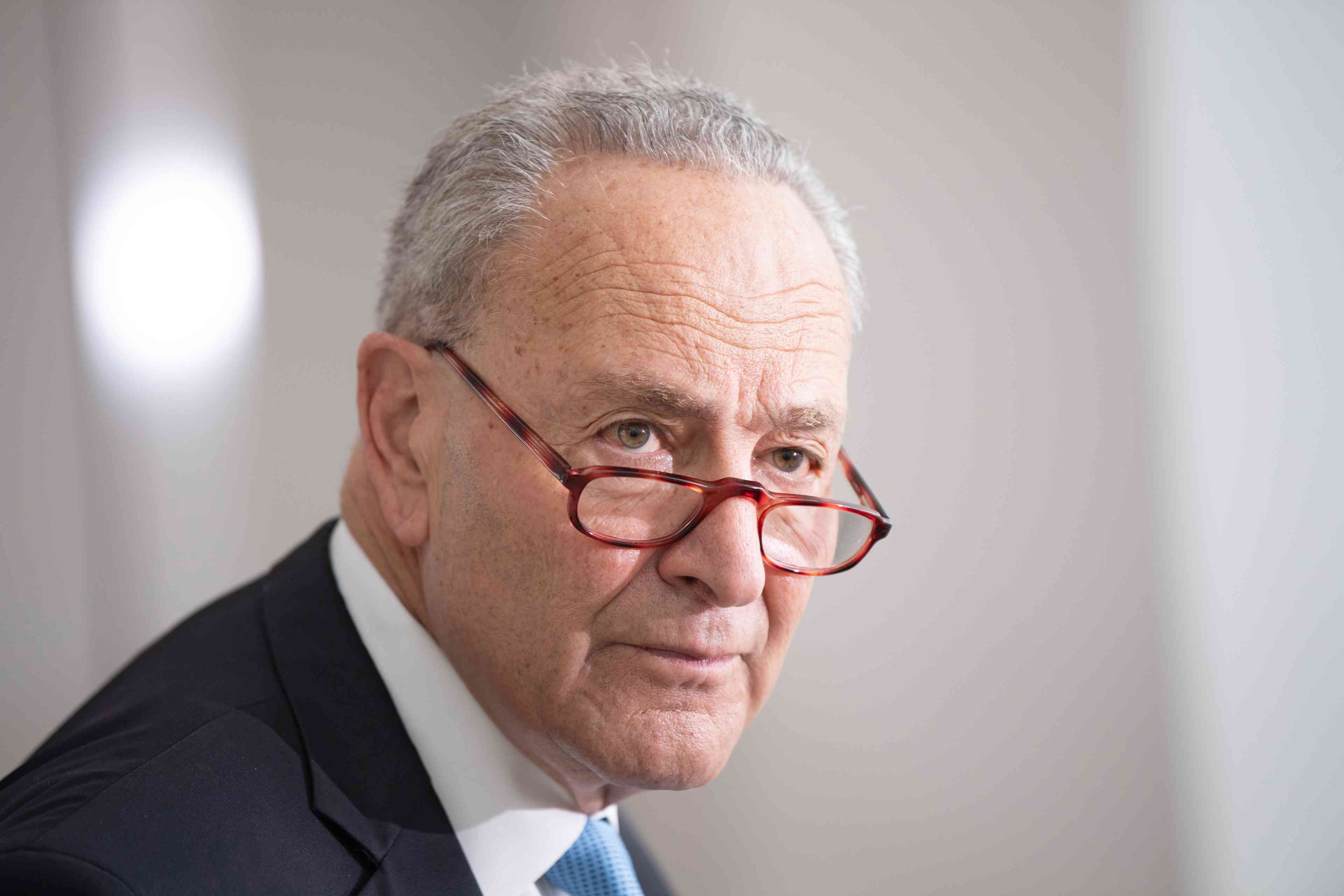 Senate Majority Leader Chuck Schumer. background