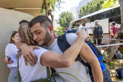 Young Israelis arrive at the IDF Bakum Reception and Sorting base in Tel Hashomer in Israel, on April 18, 2024. background