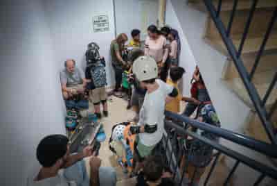 Israelis take cover inside a bomb shelter as a siren alert is sounded in Tel Aviv background