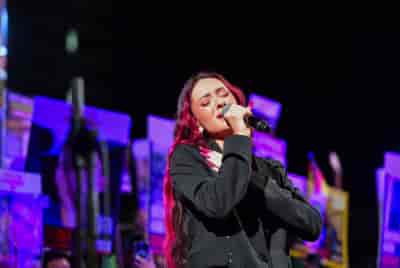 Israeli singer Eden Golan at a rally calling for the release of Israelis held hostage by Hamas terrorists background