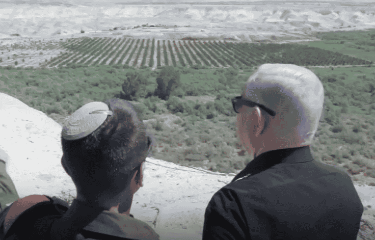 Netanyahu looking out at the Jordan River. background
