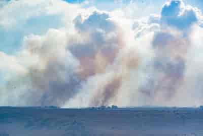 Smoke rises from a fire which broke out from missiles fired from Lebanon in the Golan Heights, on September 15, 2024. background