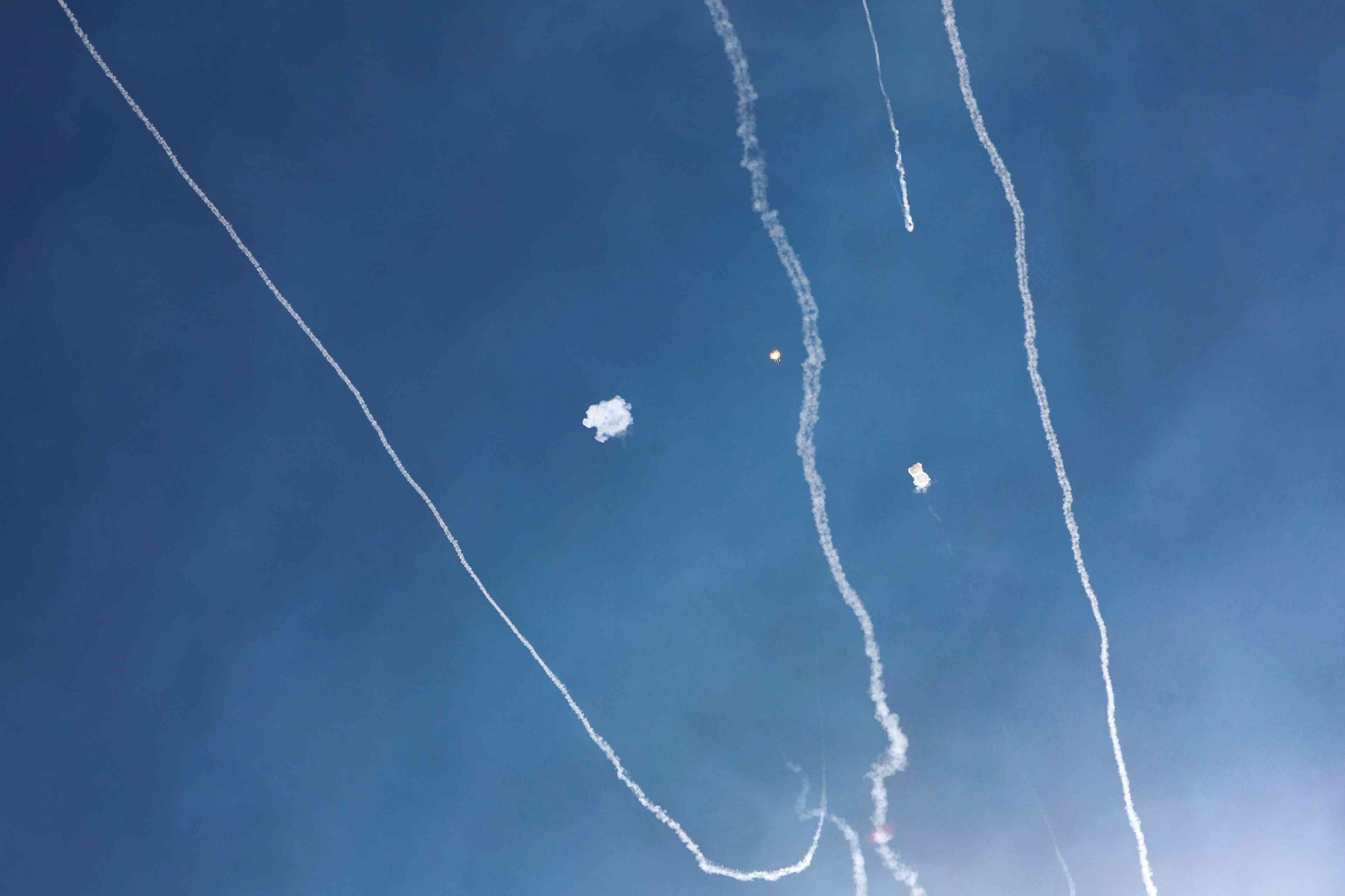 An Israeli anti missile system intercept missiles fired from Lebanon near as it seen from the northern Israeli city of Tzfat, on September 23, 2024. background