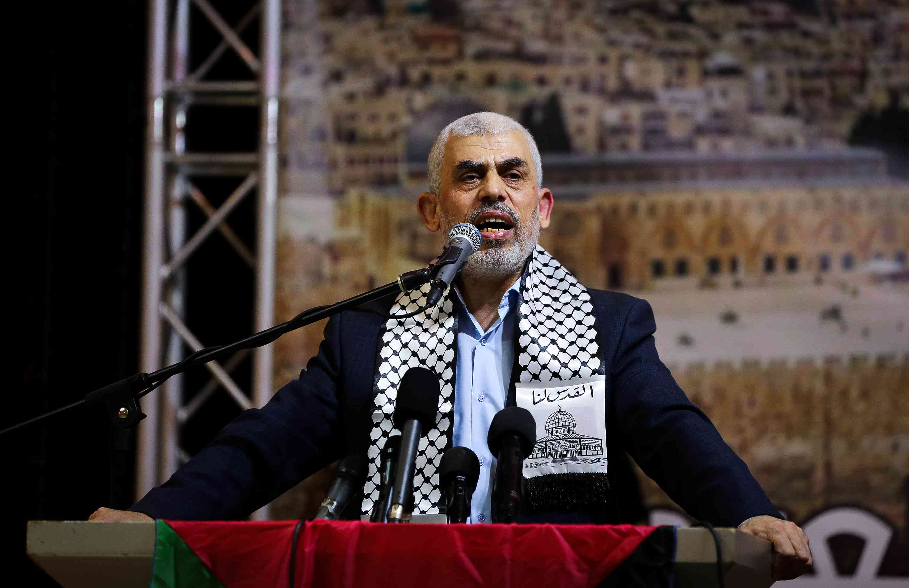 Hamas leader Yahya Sinwar. background