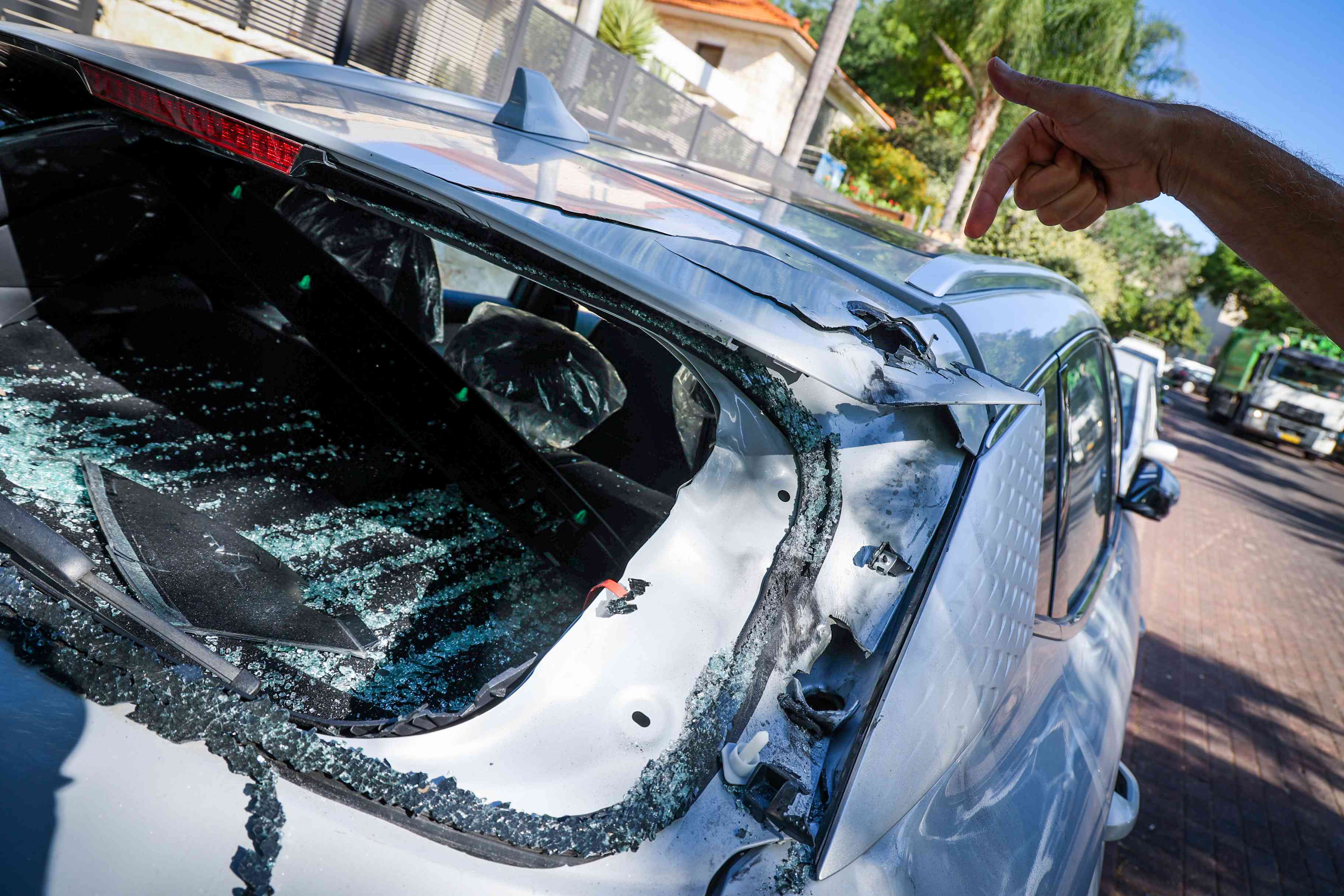 Car hit by shrapnel from a missile, in Nof Ayalon, central Israel, September 27, 2024.  background
