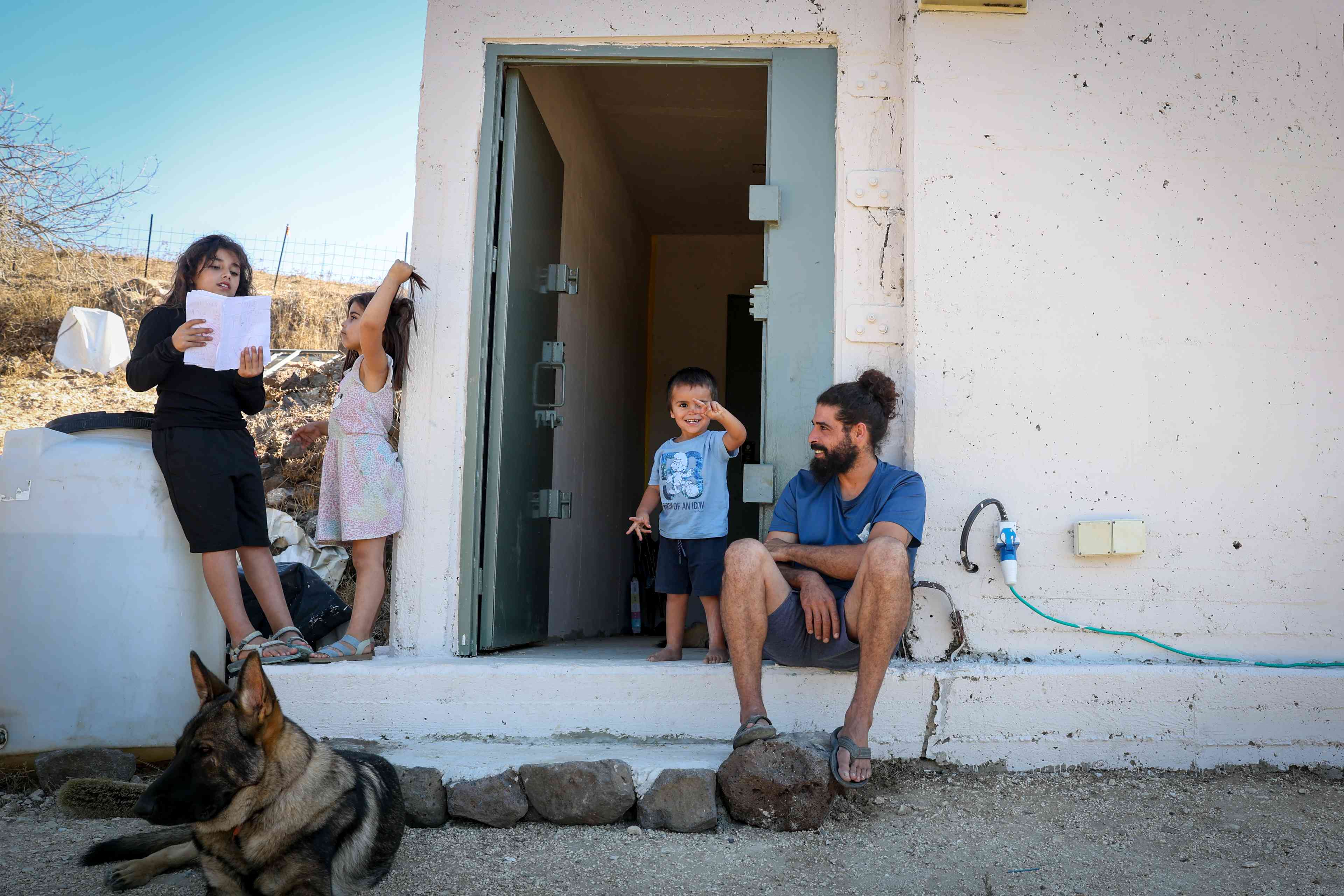 An Israeli family seen outside a public bombshelter in Kaditha, Northern Israel. September 29, 2024. background