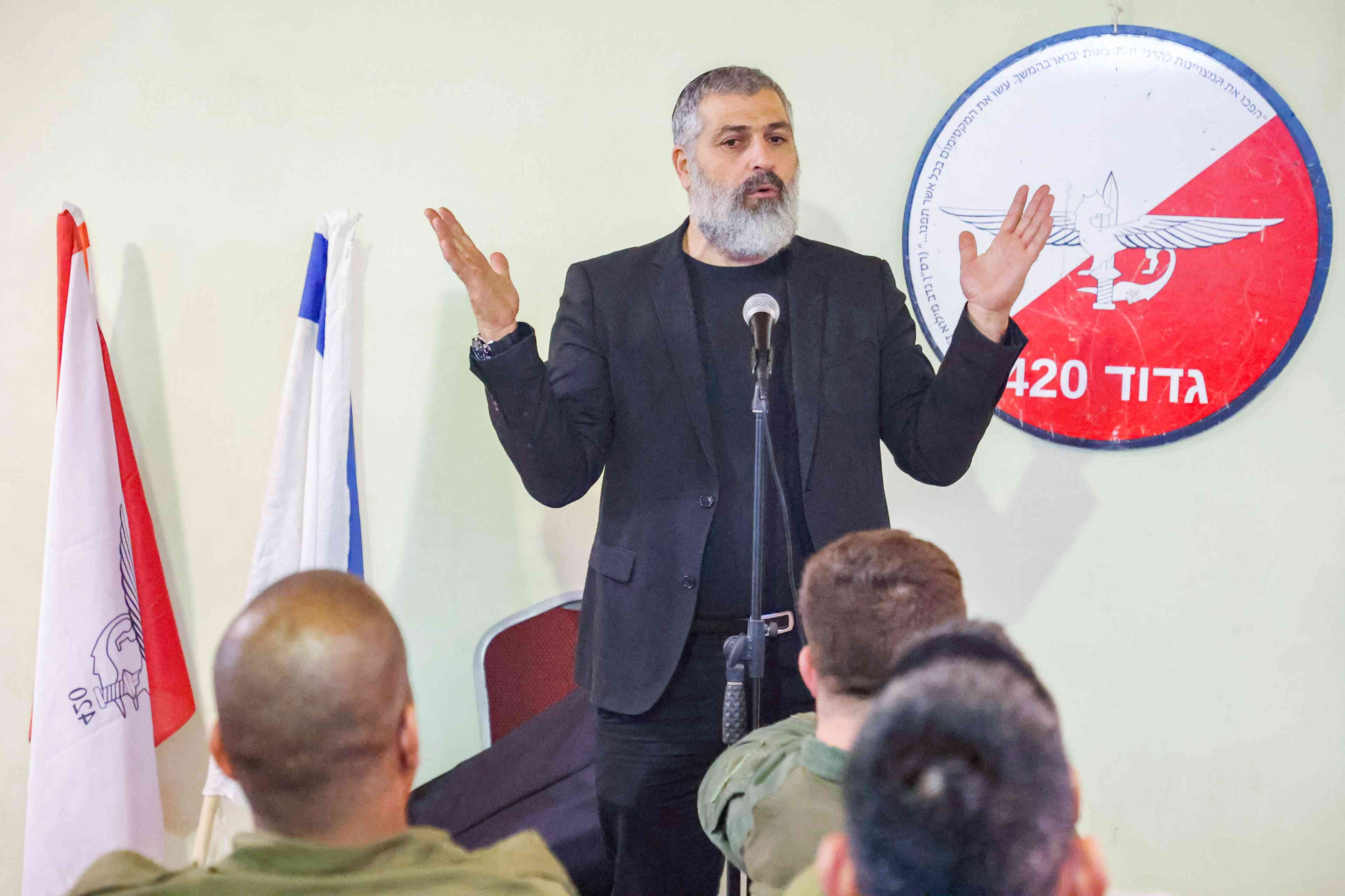 Zvi Yehezkeli, Channel 13 News reporter speaks with Israeli reserve soldiers from the Paratroopers Brigade who returned home after four and a half months, in Gush Etzion, in the West Bank, February 19, 2024. background