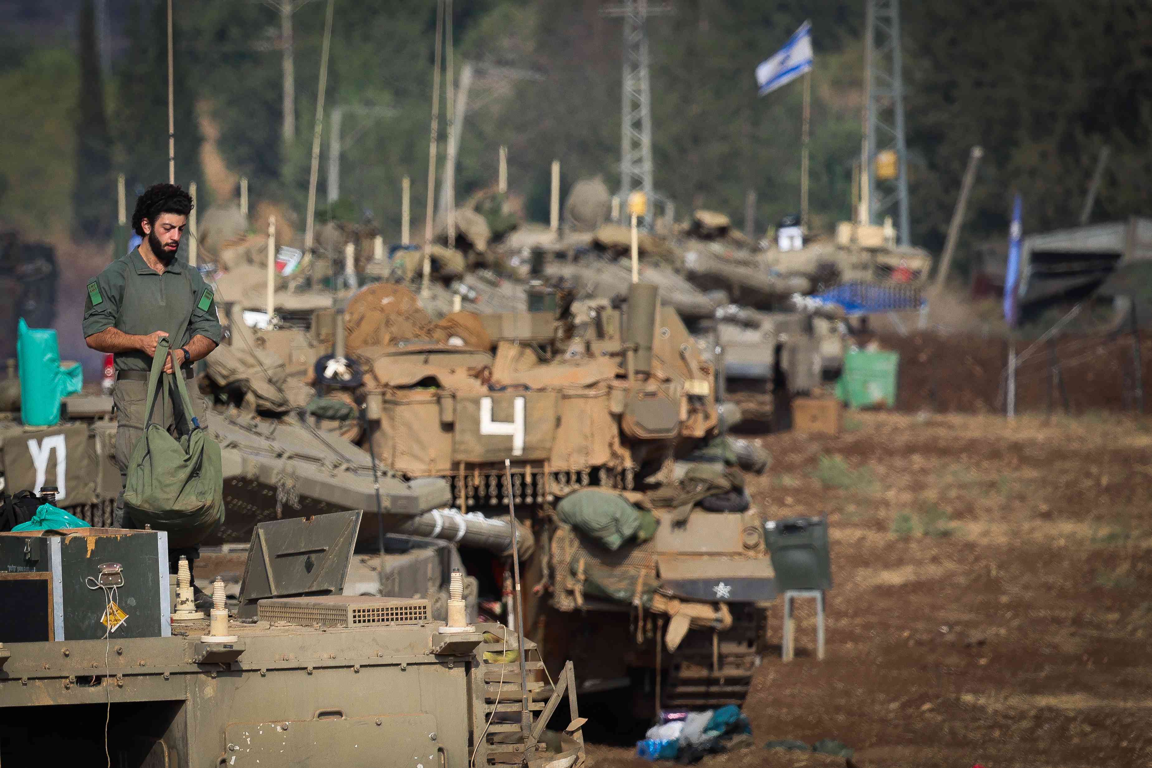 Israeli soldiers seen at a staging area near the Israeli border with Lebanon, October 1, 2024.  background