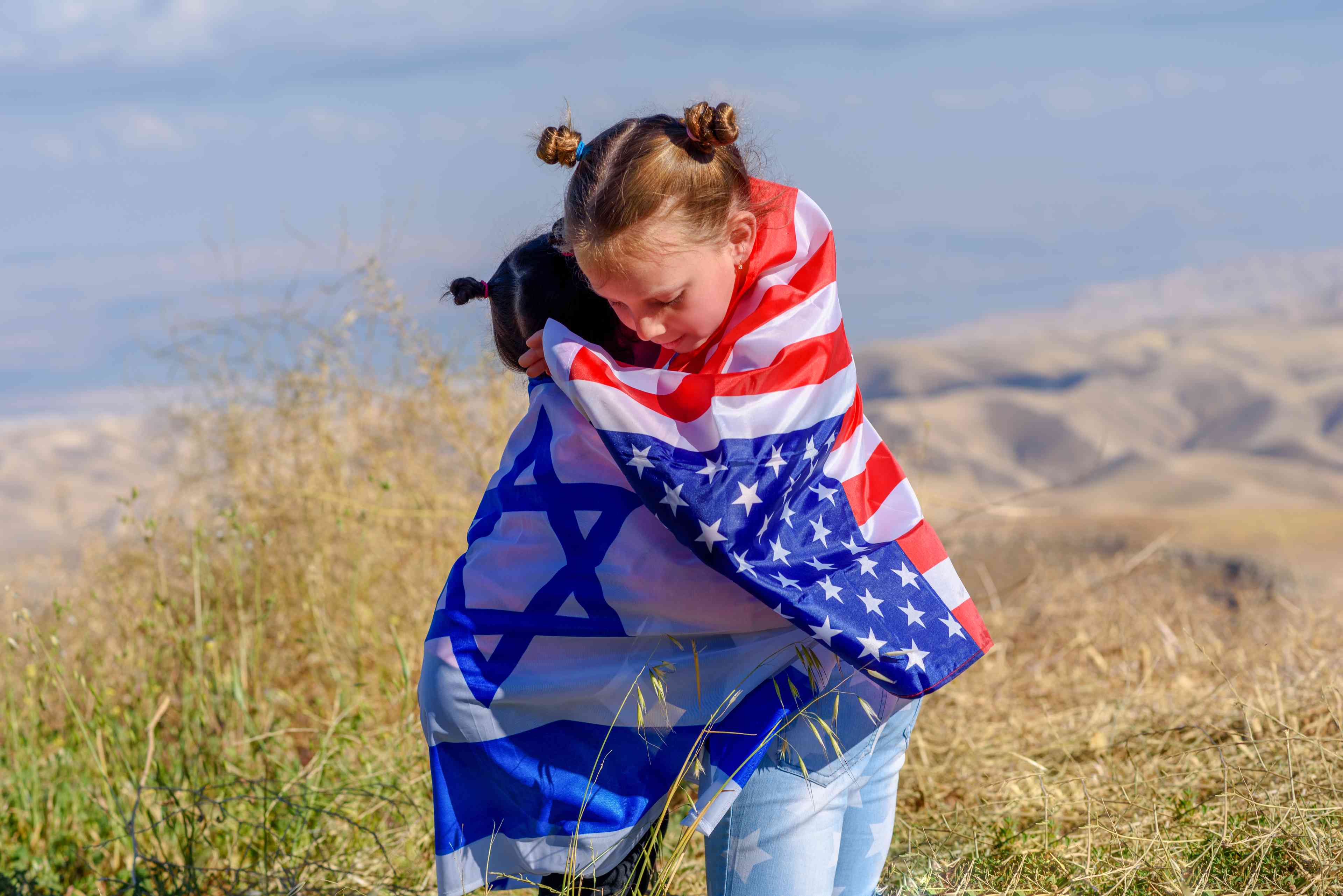 Two cute girls with American and Israel flags background