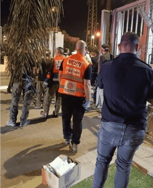 Rescue teams at the site of the Binyamina attack. background