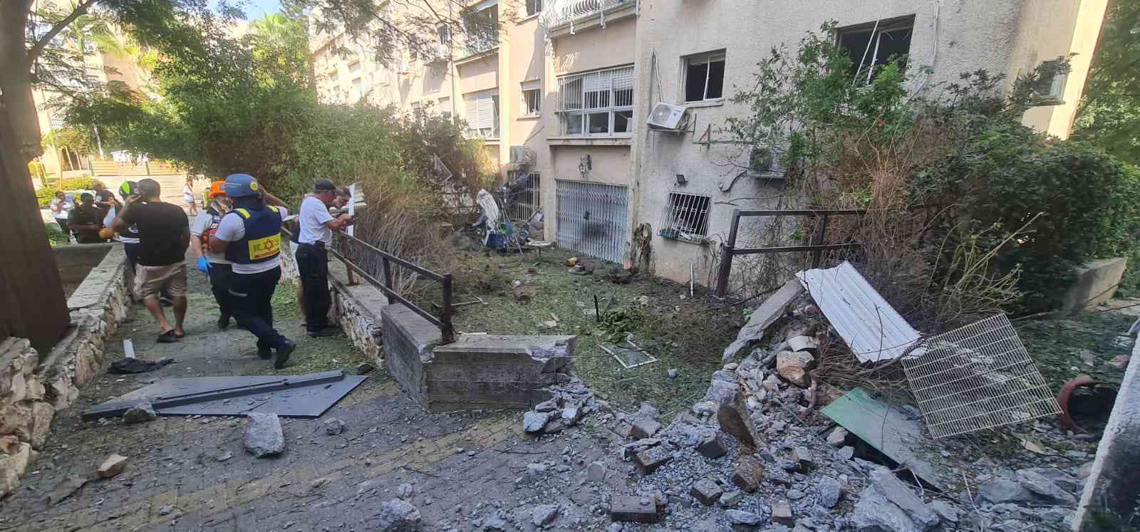 MDA paramedics at the scene of a direct hit in Haifa area background