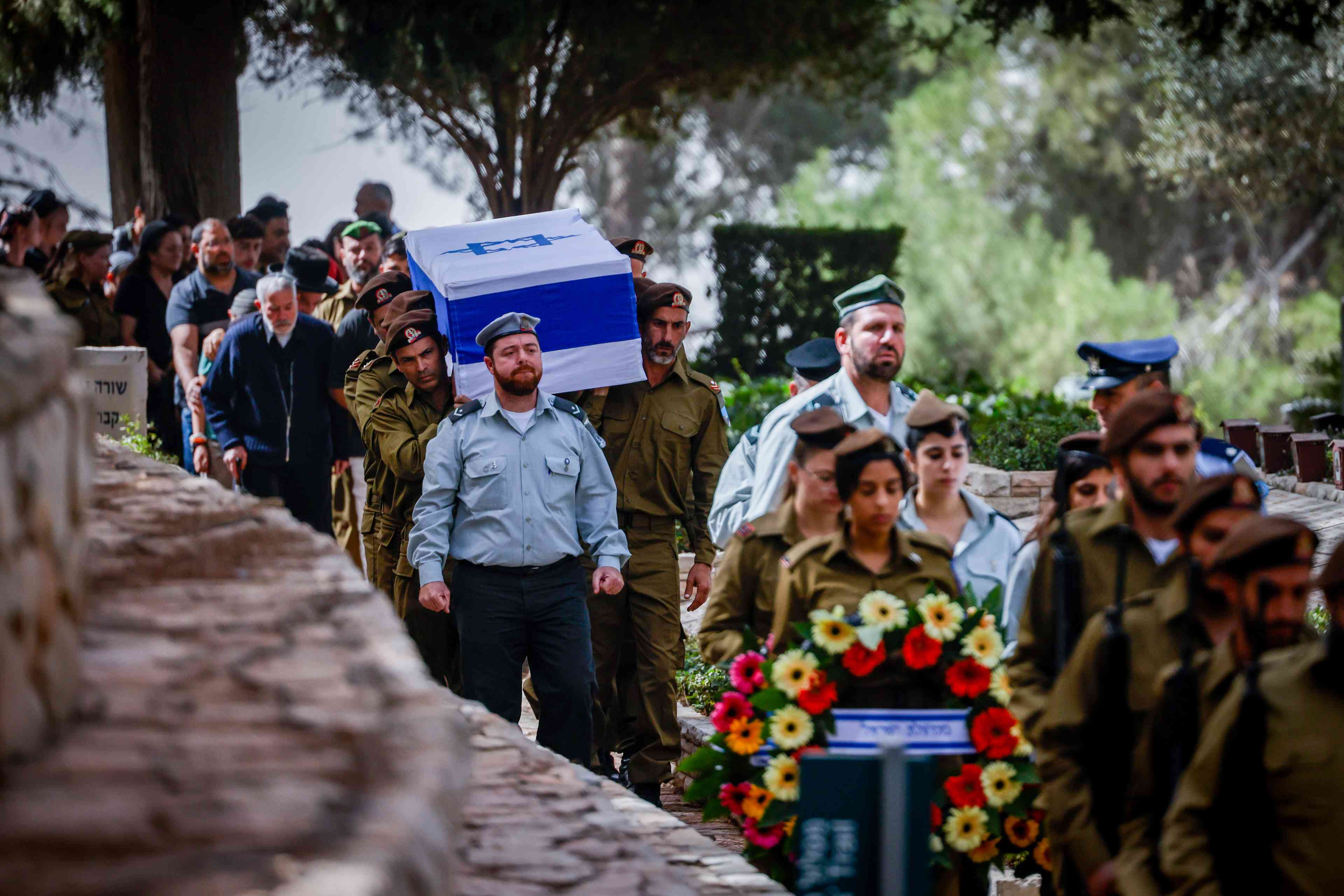Family and friends of Israeli soldier Warrant officer (res.) Mordechai Chaim Amouyal, attend his funeral at Mount Herzl Military Cemetery in Jerusalem on October 25, 2024. He fell in battle in southern Lebanon. background