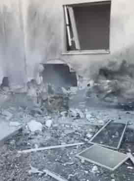 Scene of the rocket hit in Maalot Tarshicha background